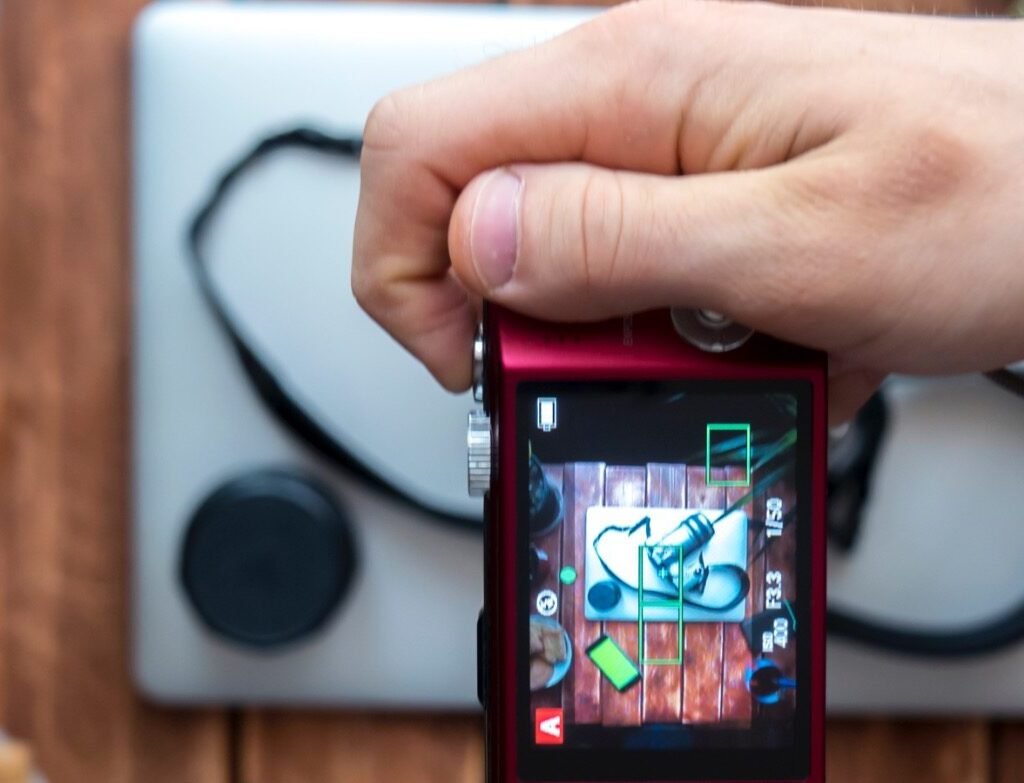 Essential Tech Gadgets Every Enthusiast Should Own in the Digital Age Overhead Photographer Making Photo With Compact Ca 2024 10 31 21 27 33 Utc E1734923726492 1024x783
